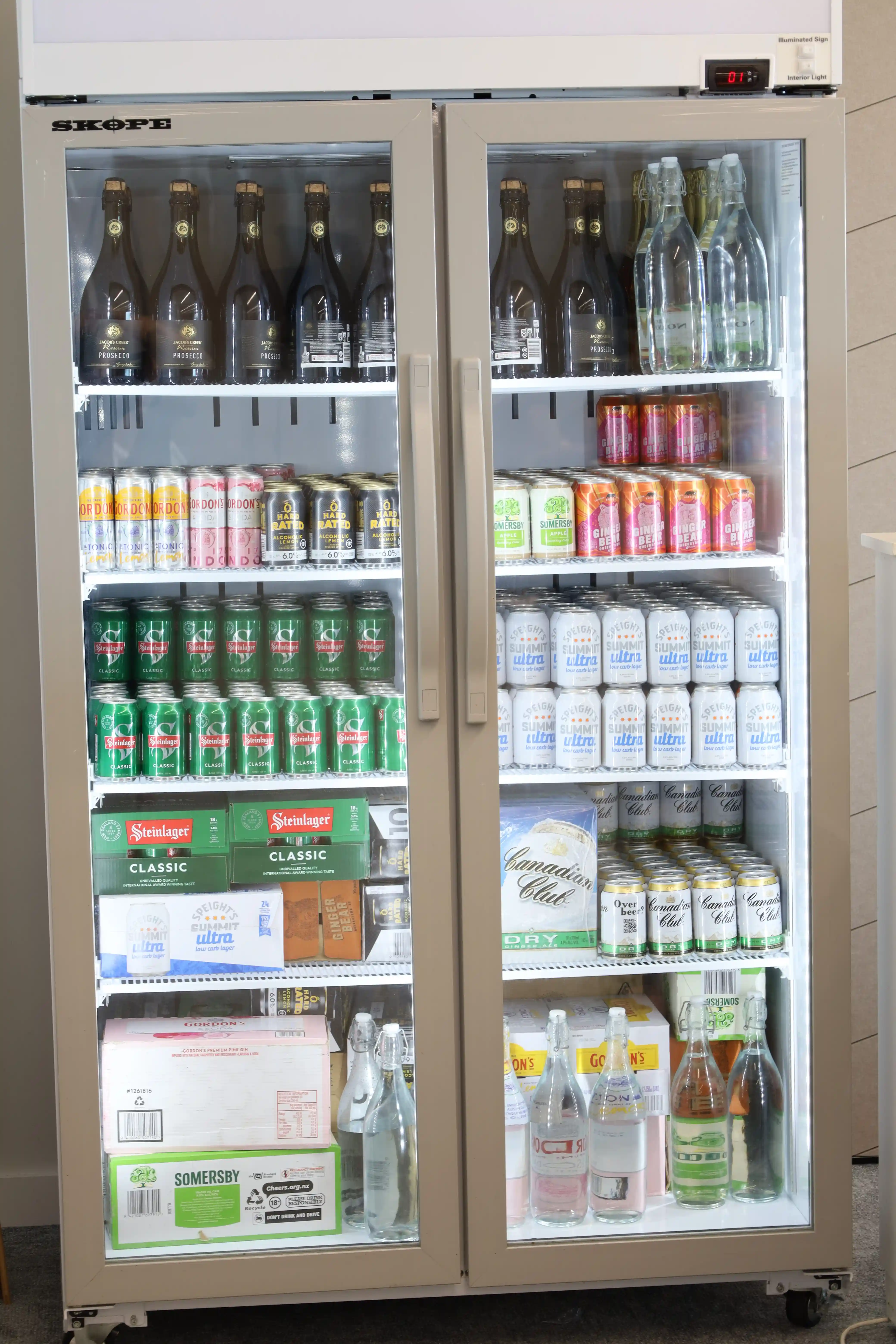 Full reception room with blue hydrangea centrepieces at Gisborne beachfront venue