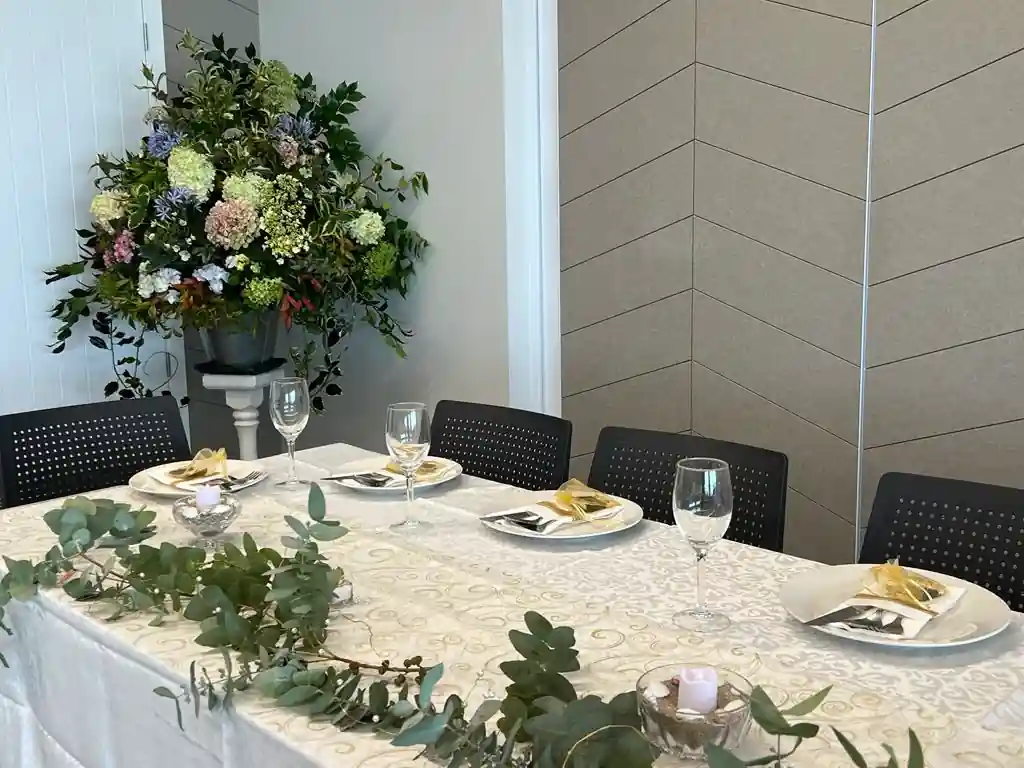 Tall floral centrepiece with eucalyptus and gold candles at Gisborne wedding