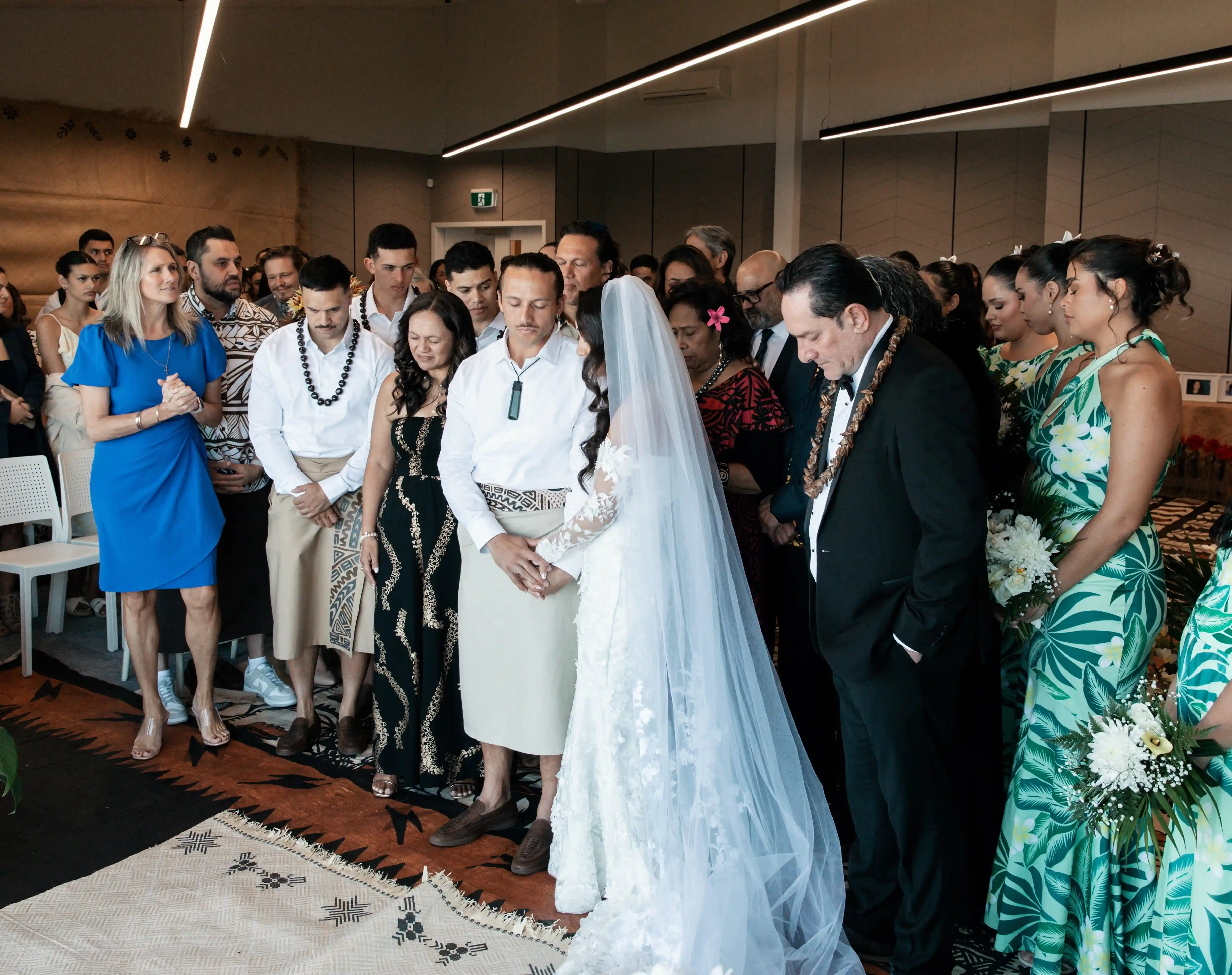 Wedding ceremony blessing with bride in cathedral veil at Gisborne venue