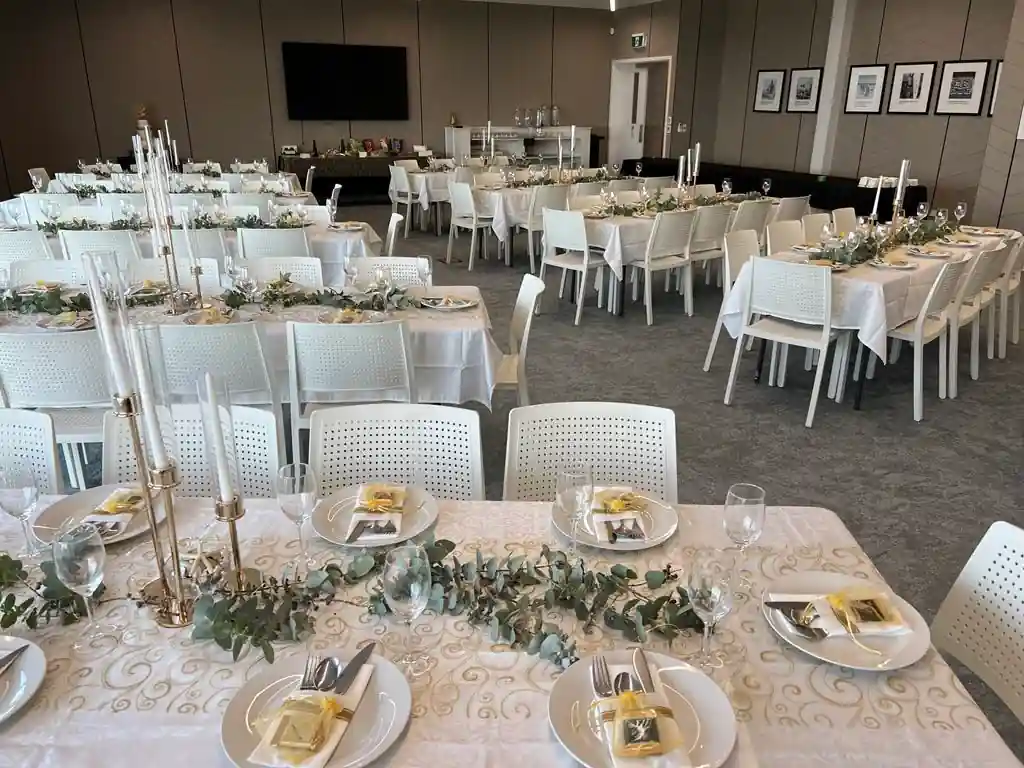 Eucalyptus candelabra centrepieces with yellow favour boxes at Gisborne wedding