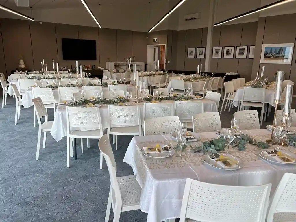 Gisborne beachfront wedding reception with white tables, silver candelabras and eucalyptus garland runners