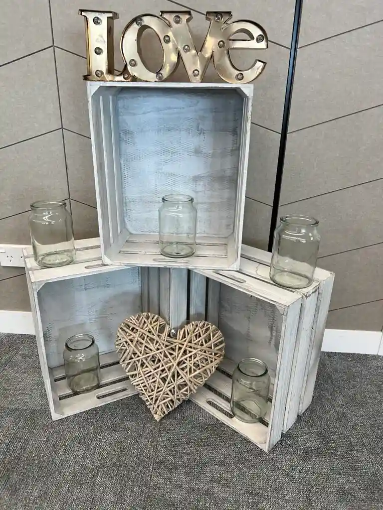 Rustic wedding decor with wooden crates, Love marquee letters and woven heart at Gisborne beachfront venue