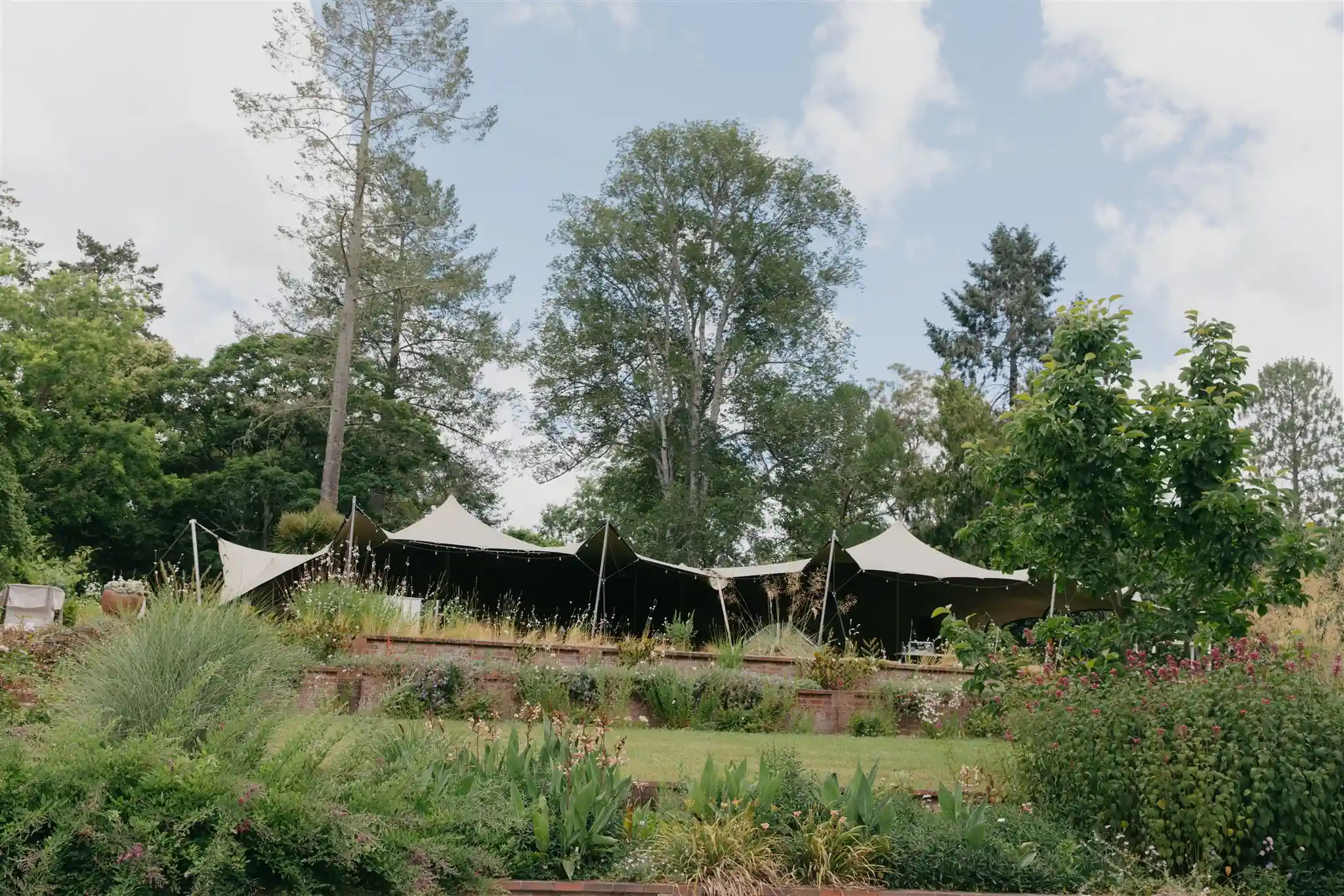 Wedding stretch tent marquee in garden at arboretum